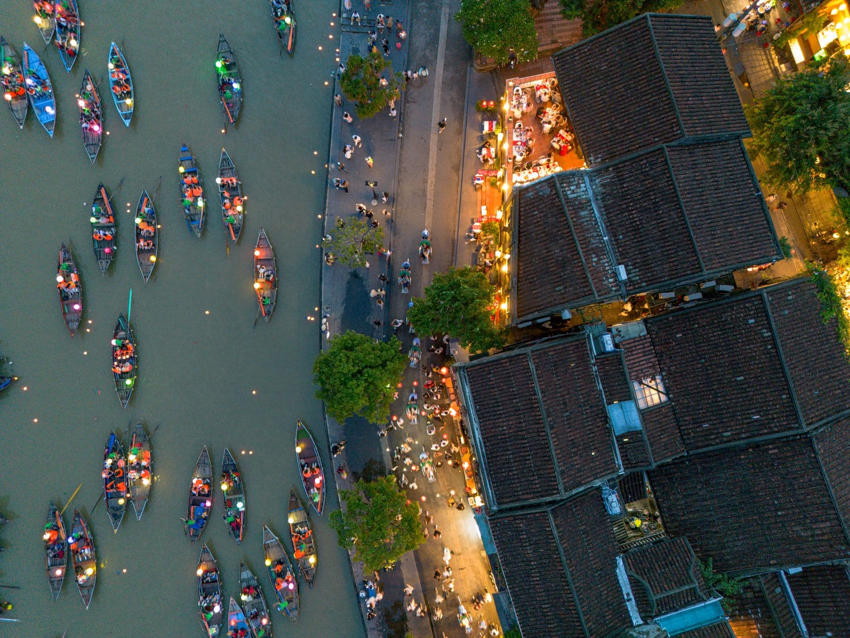 Sunrise over the Thu Bồn river in Hội An with fishing boats